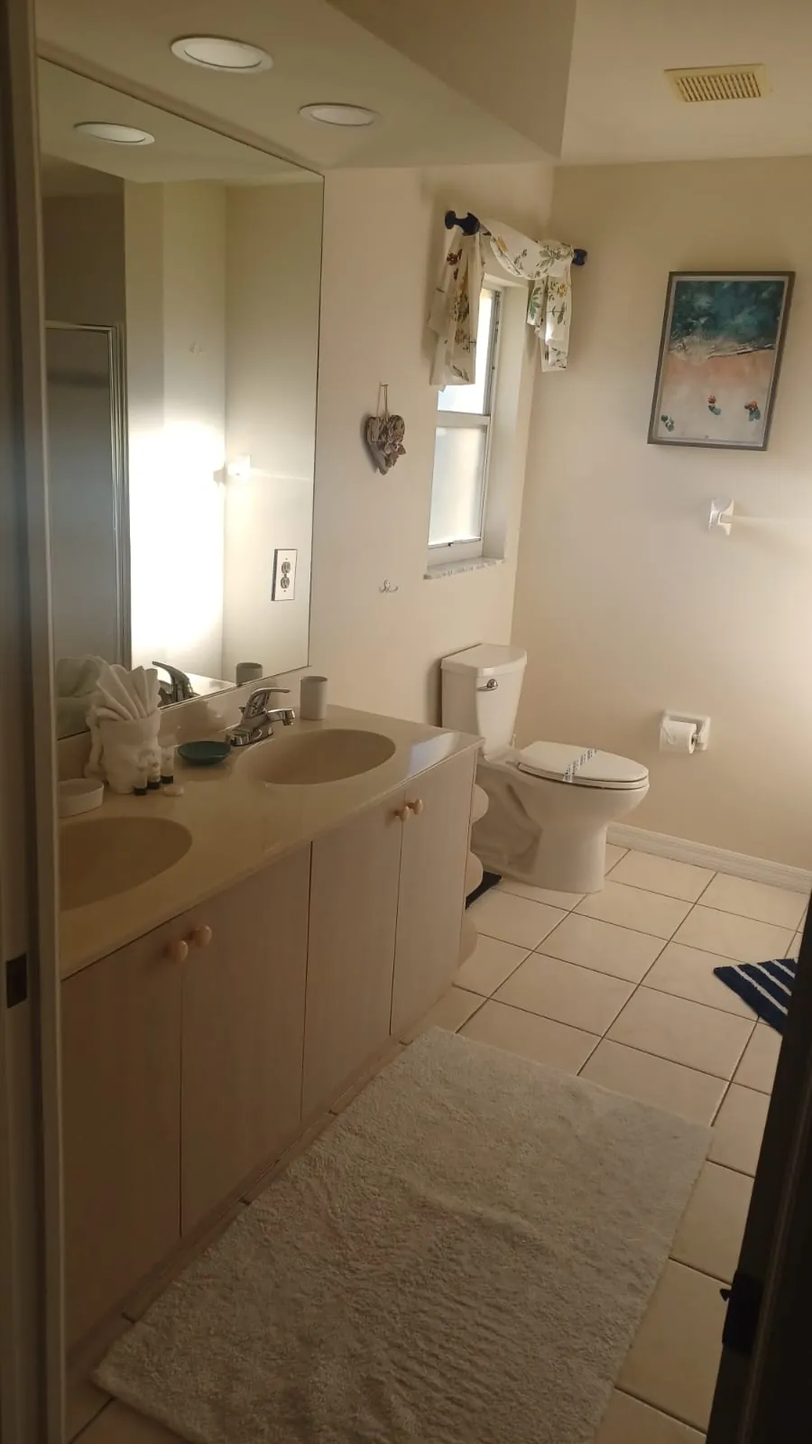 Bathroom with double vanity and shower