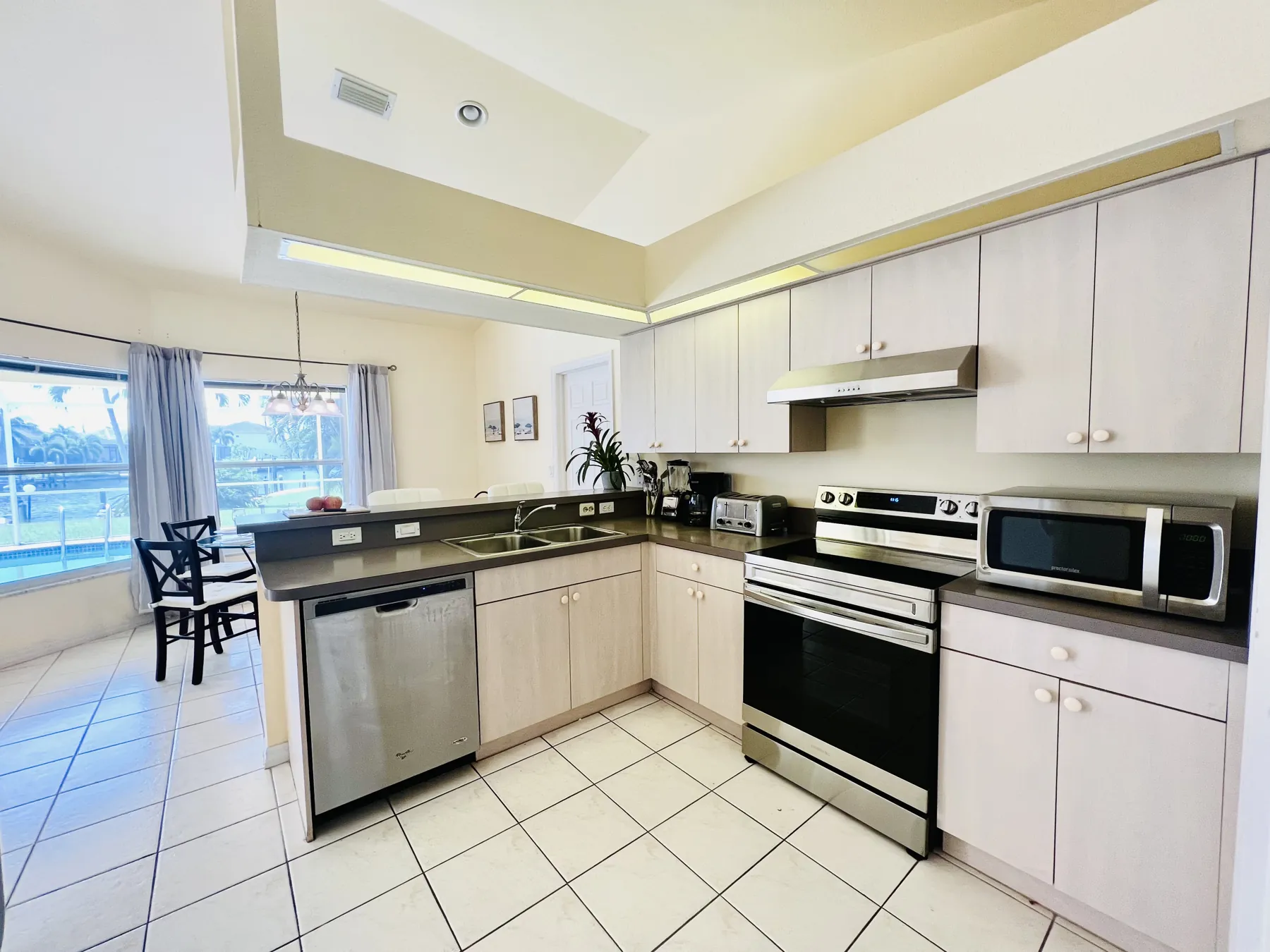 Kitchen with stainless steel appliances and breakfast bar