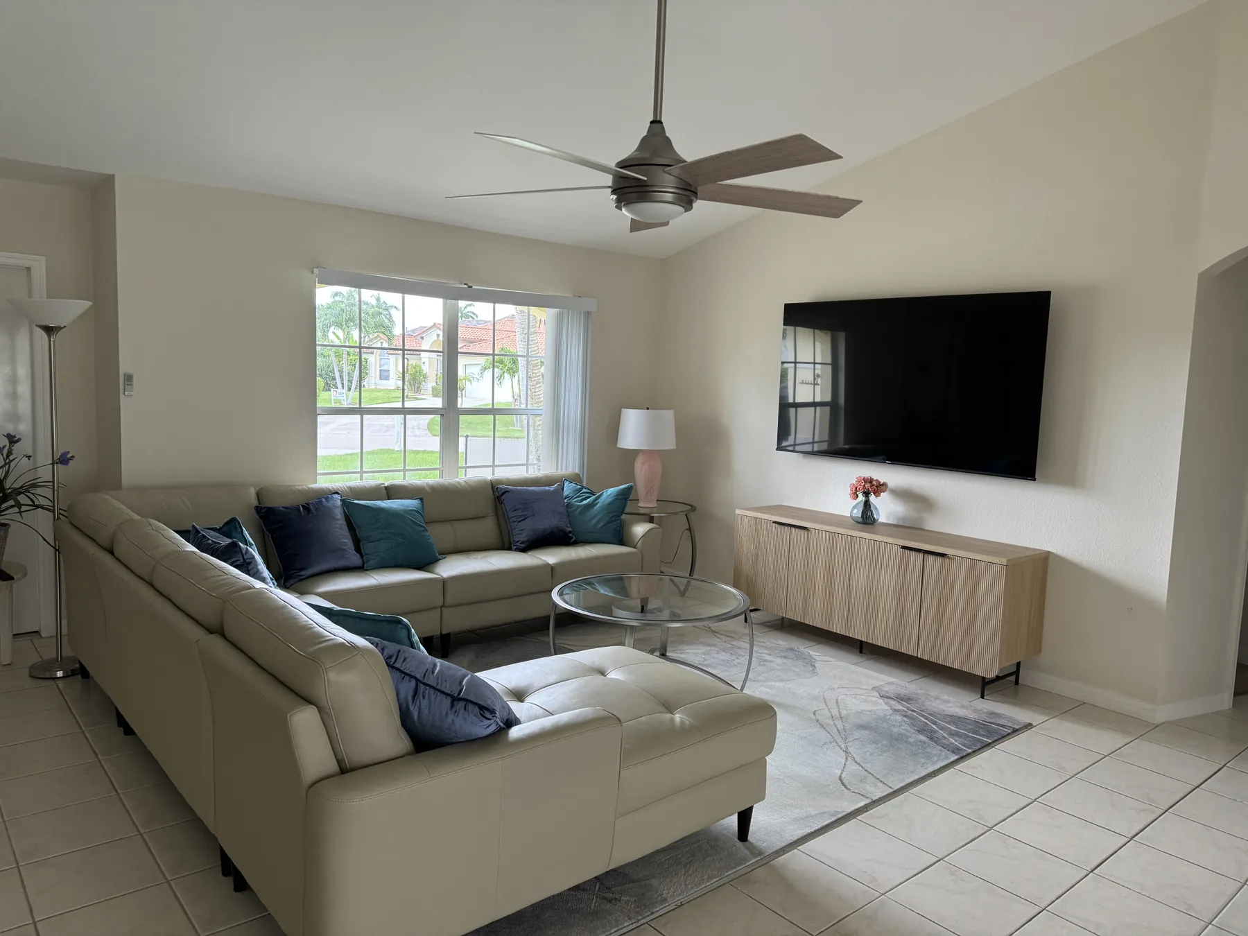 Living room with leather sectional and 75-inch TV